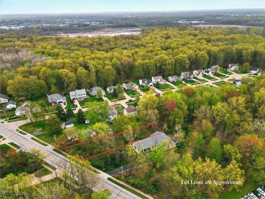 Drone / aerial view with a residential view and a view of trees