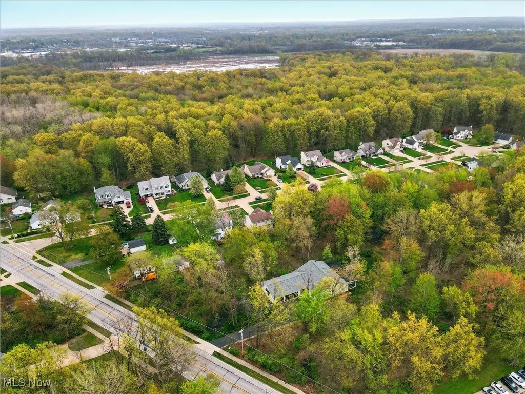 Drone / aerial view featuring a residential view and a wooded view