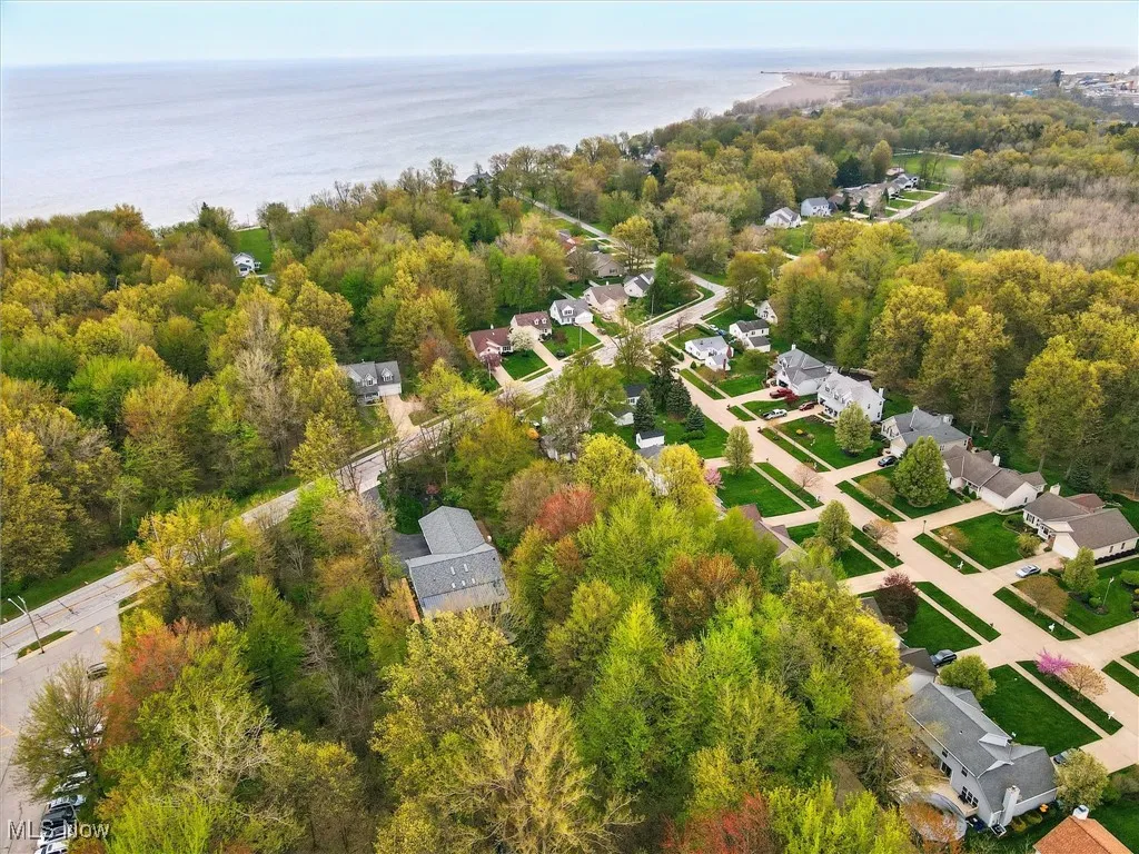 Aerial view featuring a water view, a residential view, and a wooded view