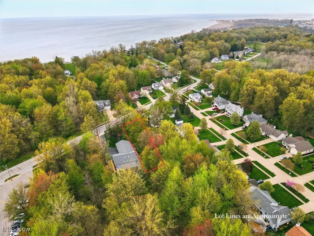 Drone / aerial view featuring a residential view, a water view, and a wooded view