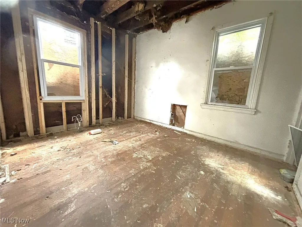Empty room featuring plenty of natural light