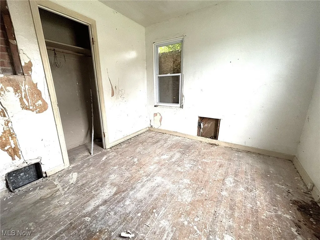 Unfurnished bedroom featuring a closet and baseboards