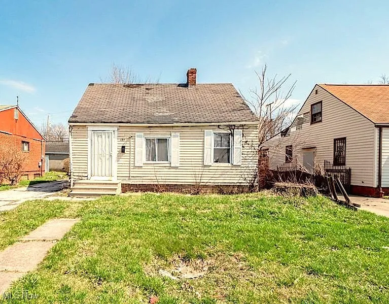 Rear view of property with a yard and a chimney