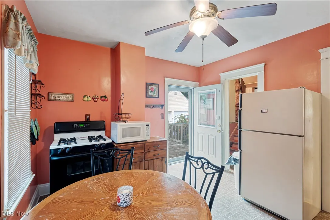 Kitchen with white appliances and ceiling fan