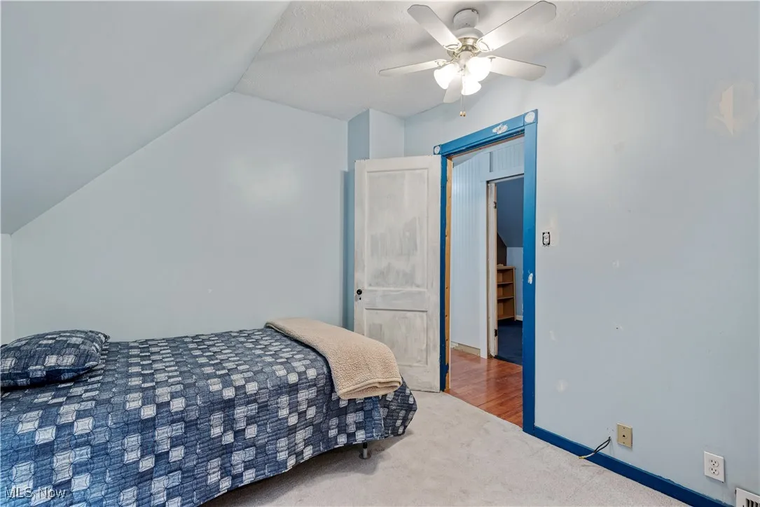 Bedroom featuring carpet flooring, lofted ceiling, and ceiling fan