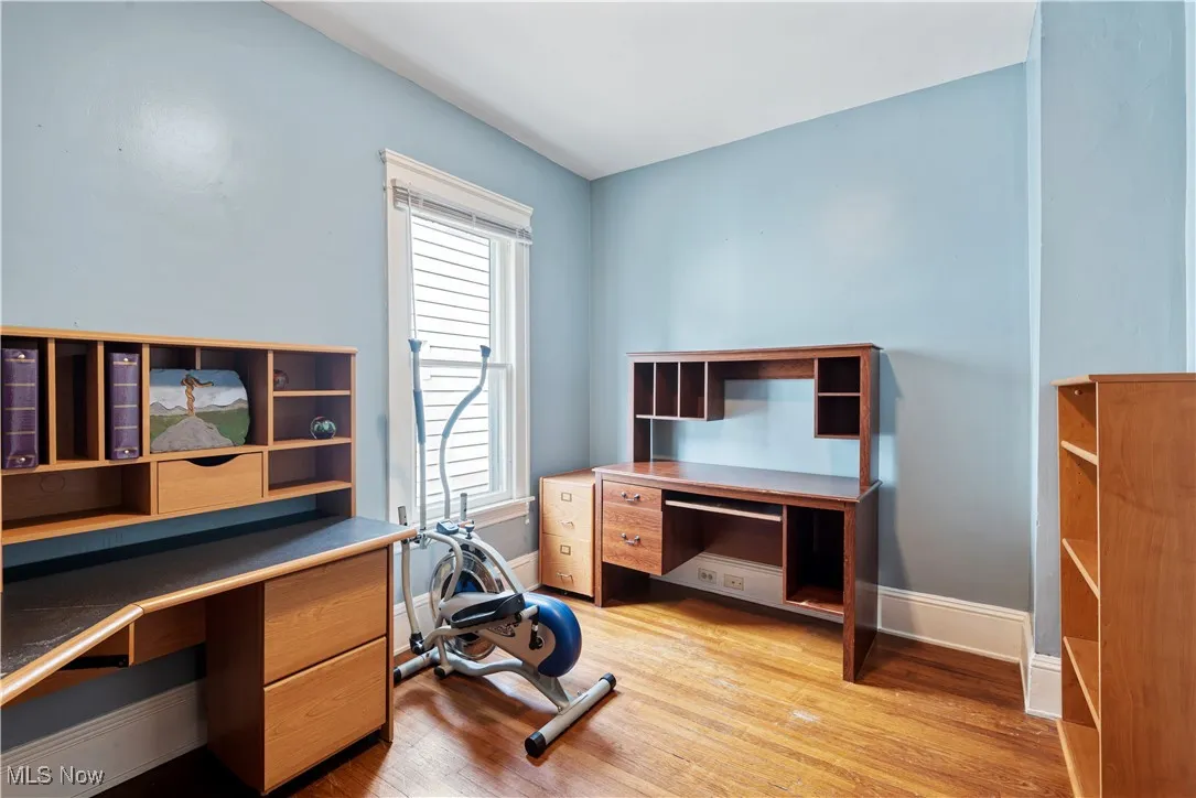 Office area featuring light wood-style floors and baseboards