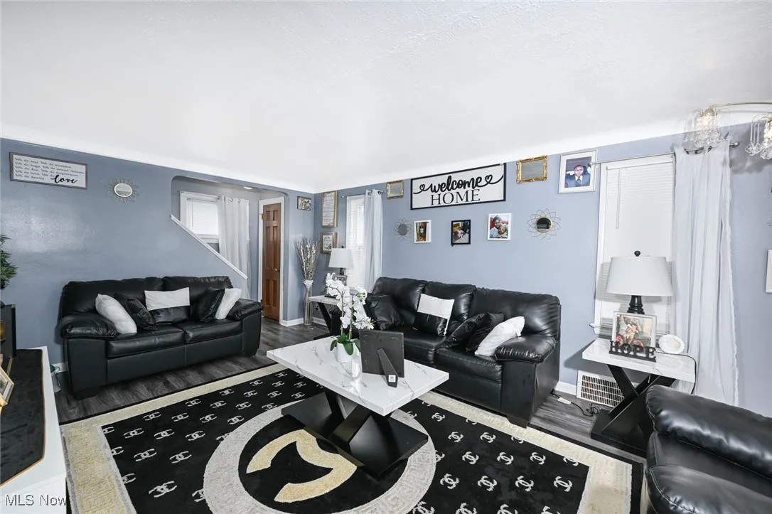Living area with wood finished floors and baseboards