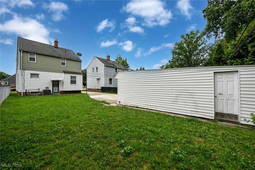Back of property with a patio and an outdoor structure