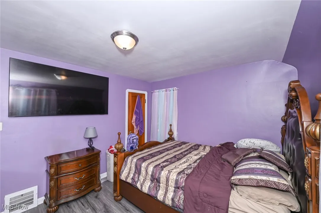 Bedroom with baseboards and wood finished floors
