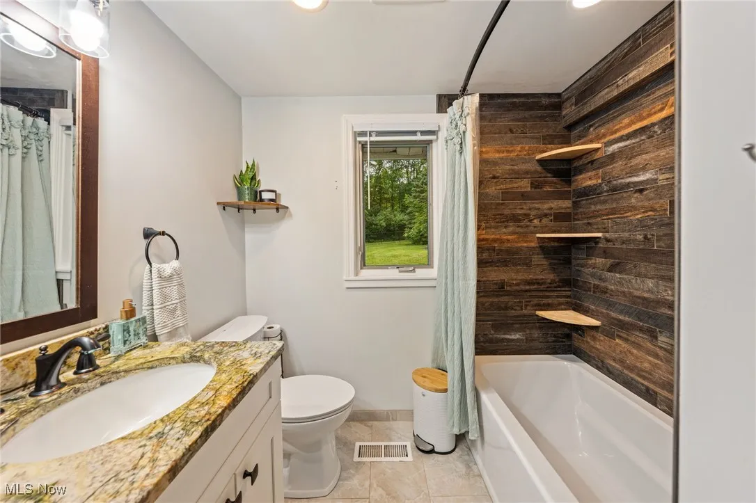 Bathroom featuring shower / tub combo, vanity, recessed lighting, and light tile patterned flooring