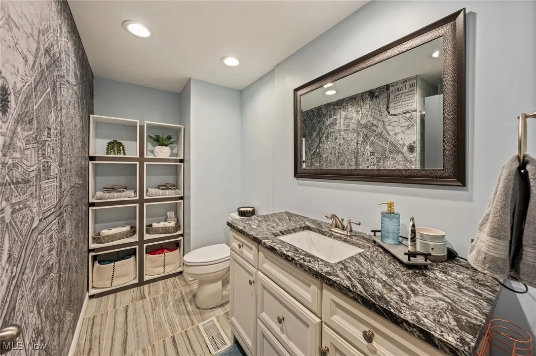 Bathroom with vanity and recessed lighting