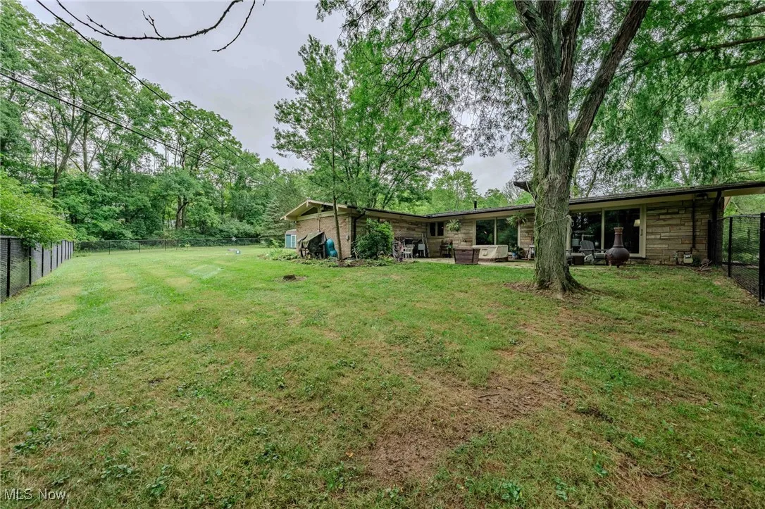 Fenced backyard with a patio