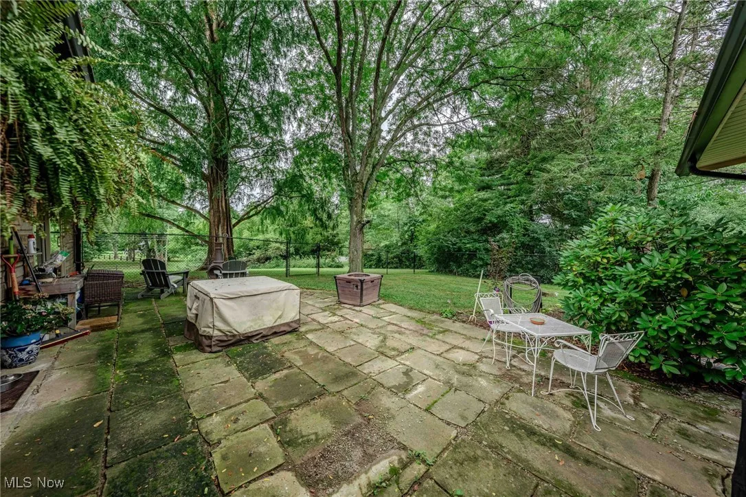 View of patio with an outdoor fire pit