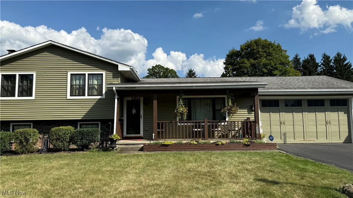 Split level home featuring covered porch, a 2 car attached garage.