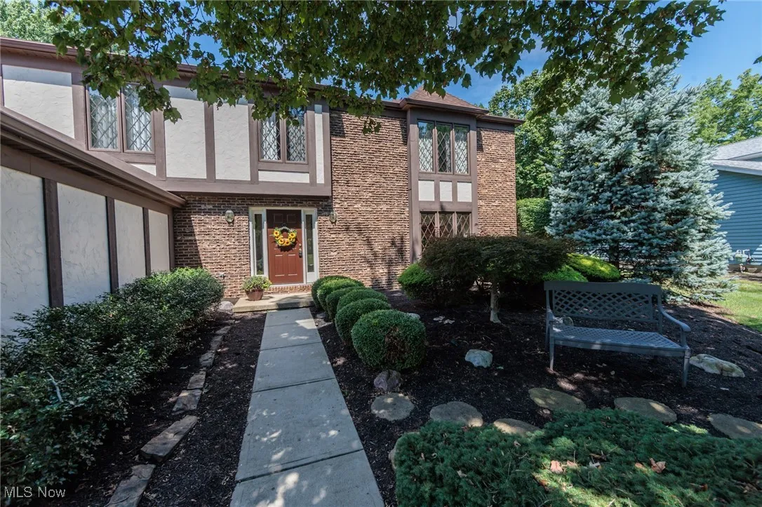 Entrance to property with brick siding and stucco siding