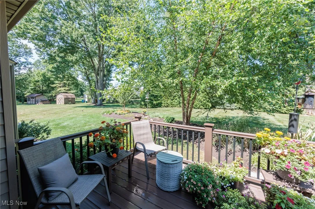 Wooden deck with a shed and a lawn
