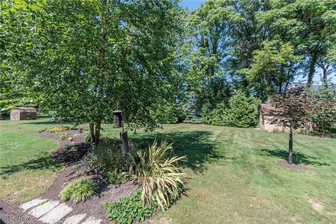 View of grassy yard featuring a storage shed