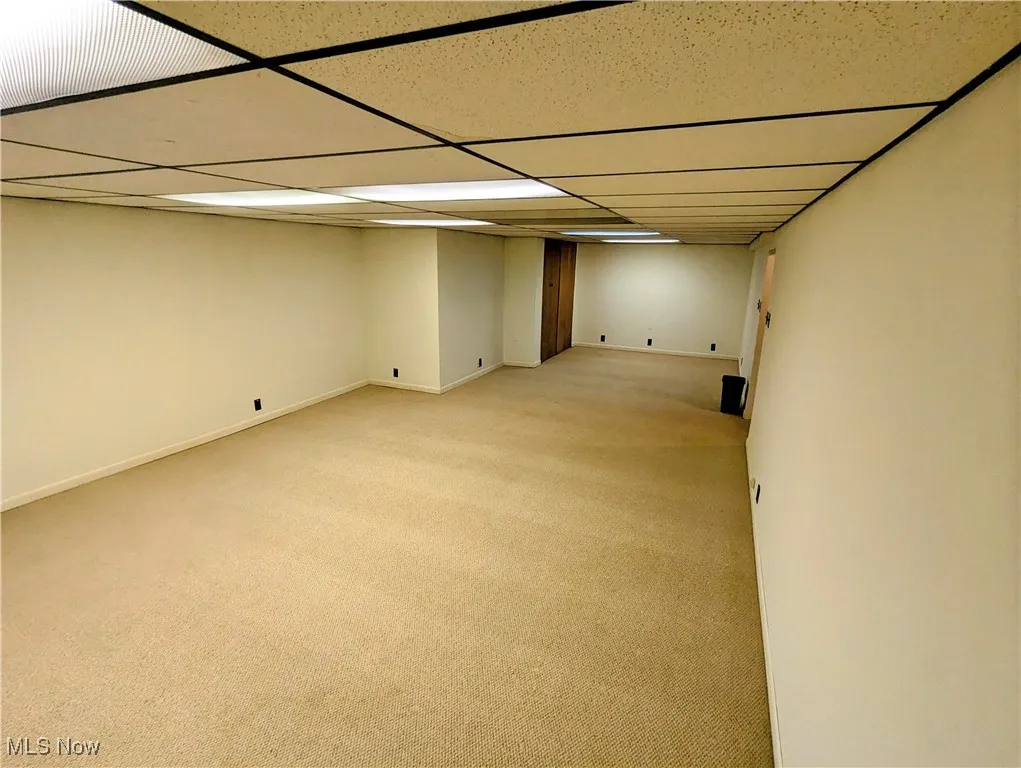 Finished below grade area with carpet and a drop ceiling