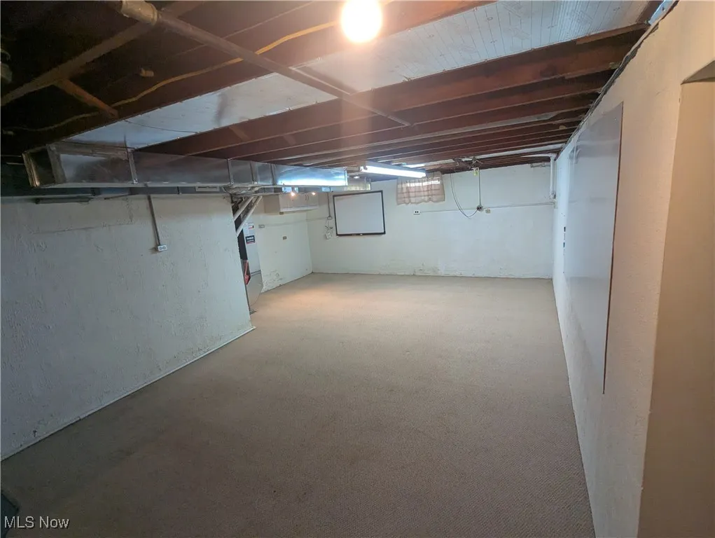 additional view of basement with carpeting and wall mounted whiteboards