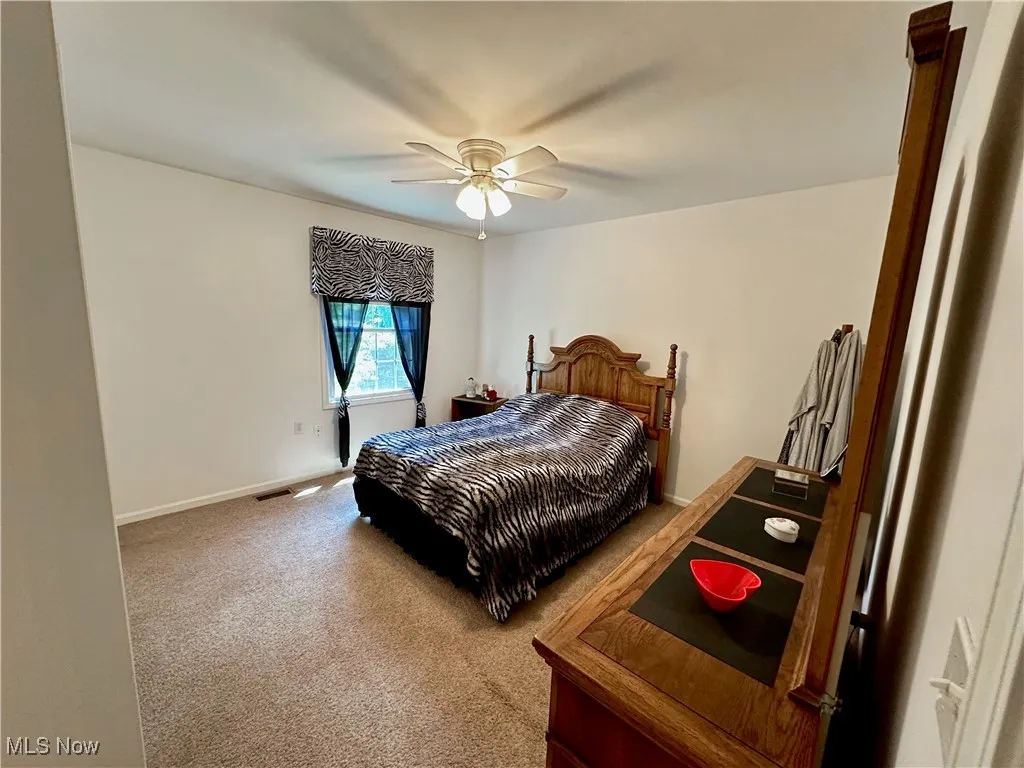 Bedroom with carpet flooring and a ceiling fan