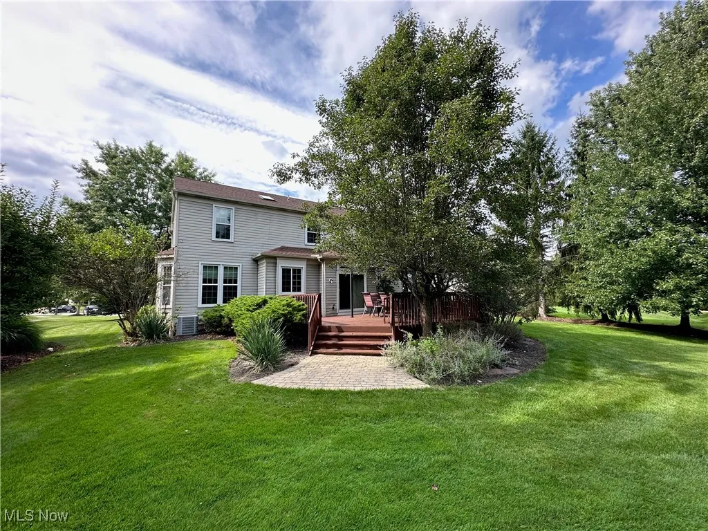 Back of house featuring a yard and a deck