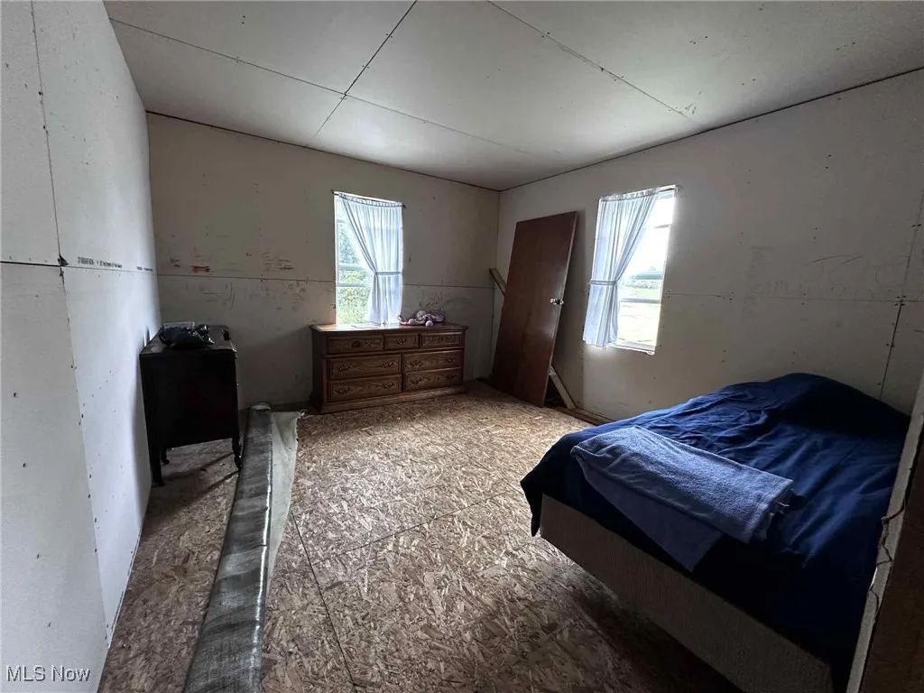 Bedroom featuring multiple windows