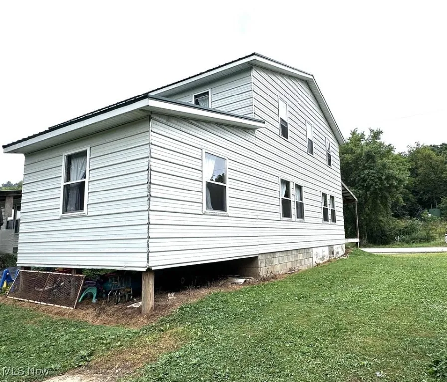 View of side of property with a yard
