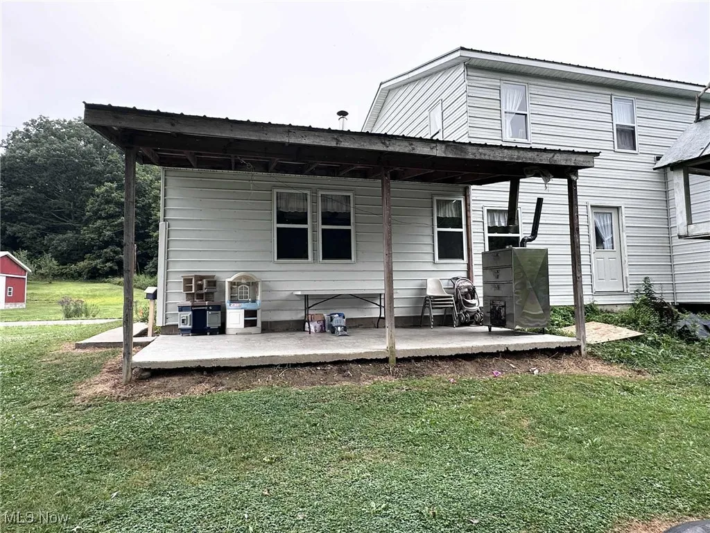 Back of house with a yard and a wooden deck