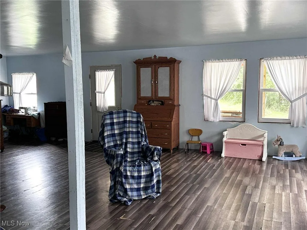 Living area featuring healthy amount of natural light and dark wood-style​​‌​​​​‌​​‌‌​‌‌​​​‌‌​‌​‌​‌​​​‌​​ floors