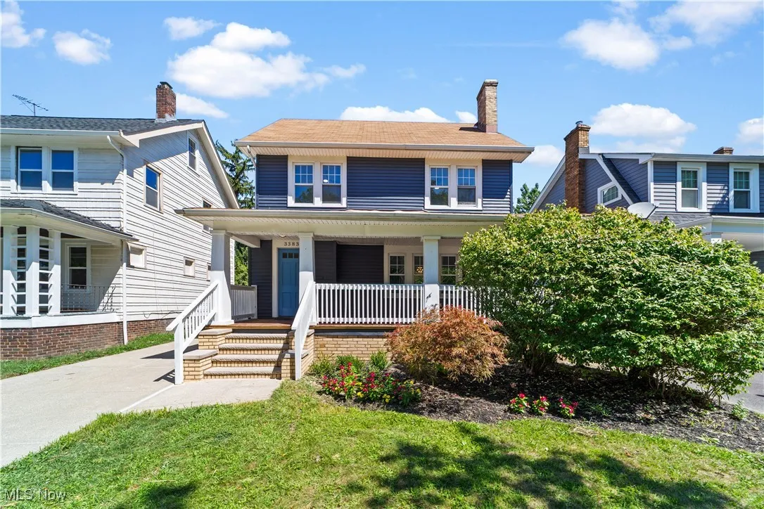 Traditional style home with a porch, a front lawn, and a chimney