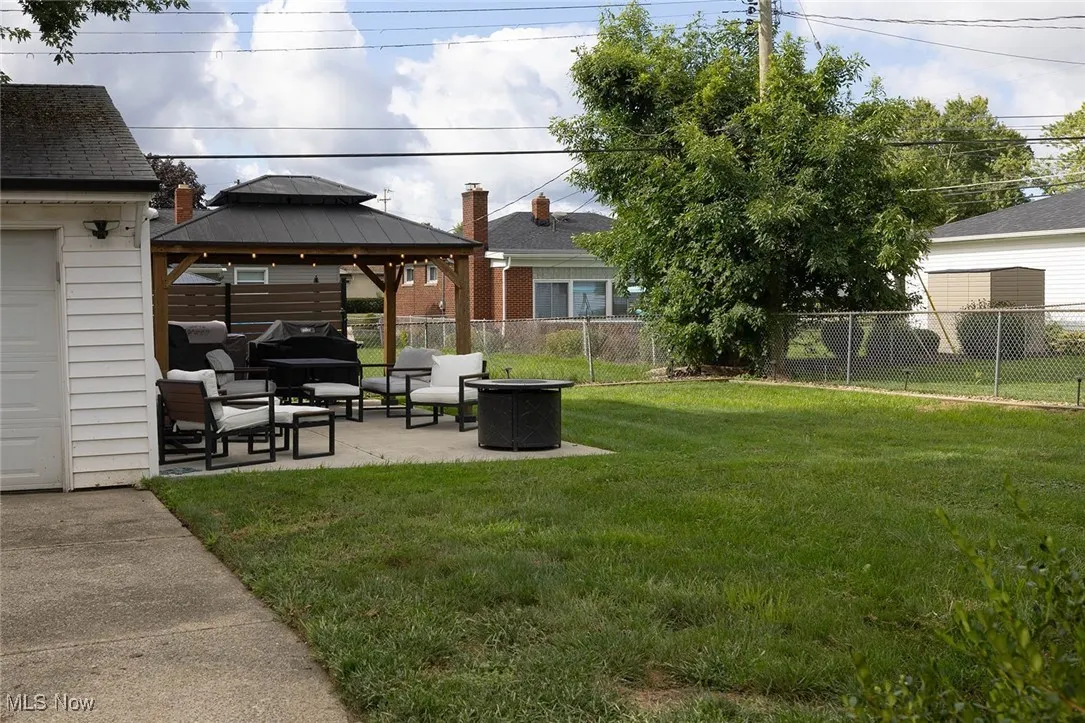 View of yard featuring a patio area, an outdoor hangout area, a gazebo, and a garage