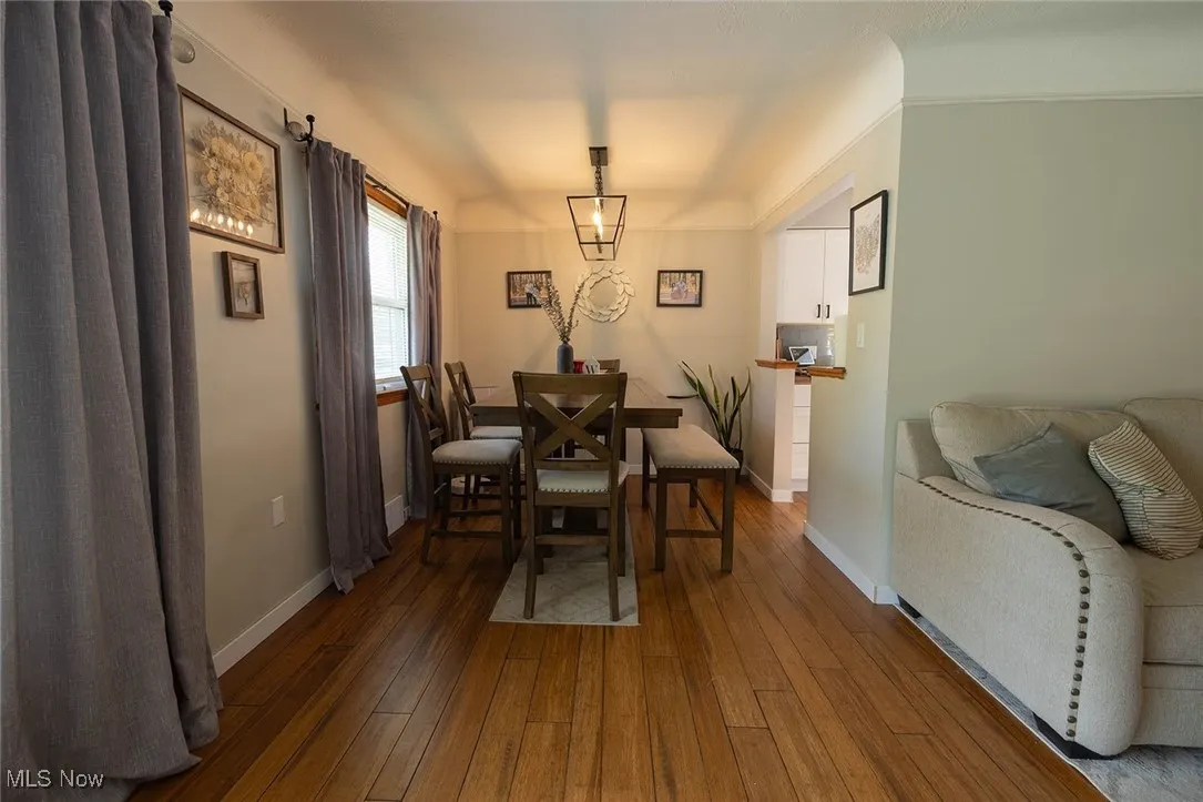 Dining space with hardwood / wood-style floors