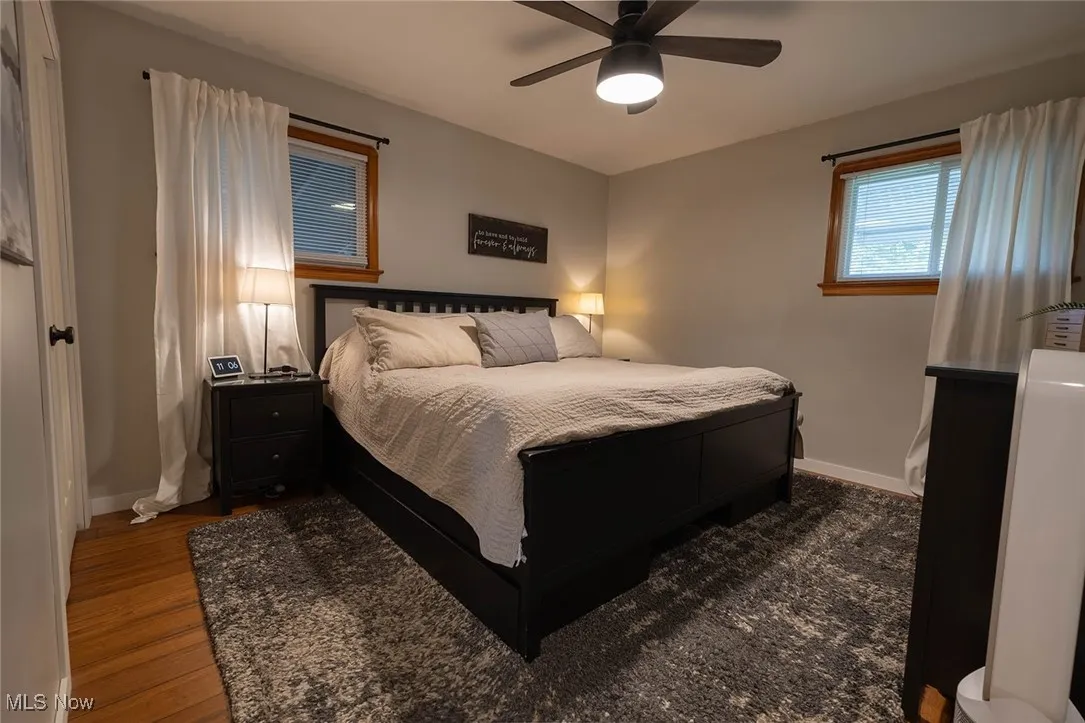 Bedroom featuring ceiling fan and dark wood-style flooring