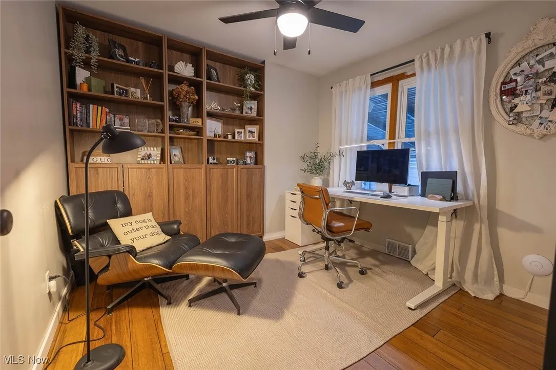 Office with wood finished floors and ceiling fan