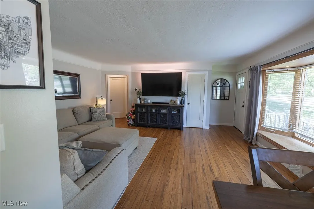 Living area with wood-type flooring and baseboards