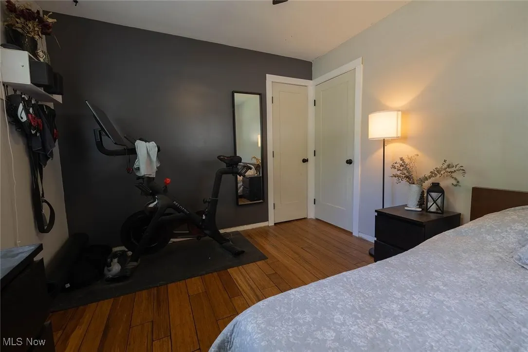 Bedroom featuring baseboards and dark wood-style floors