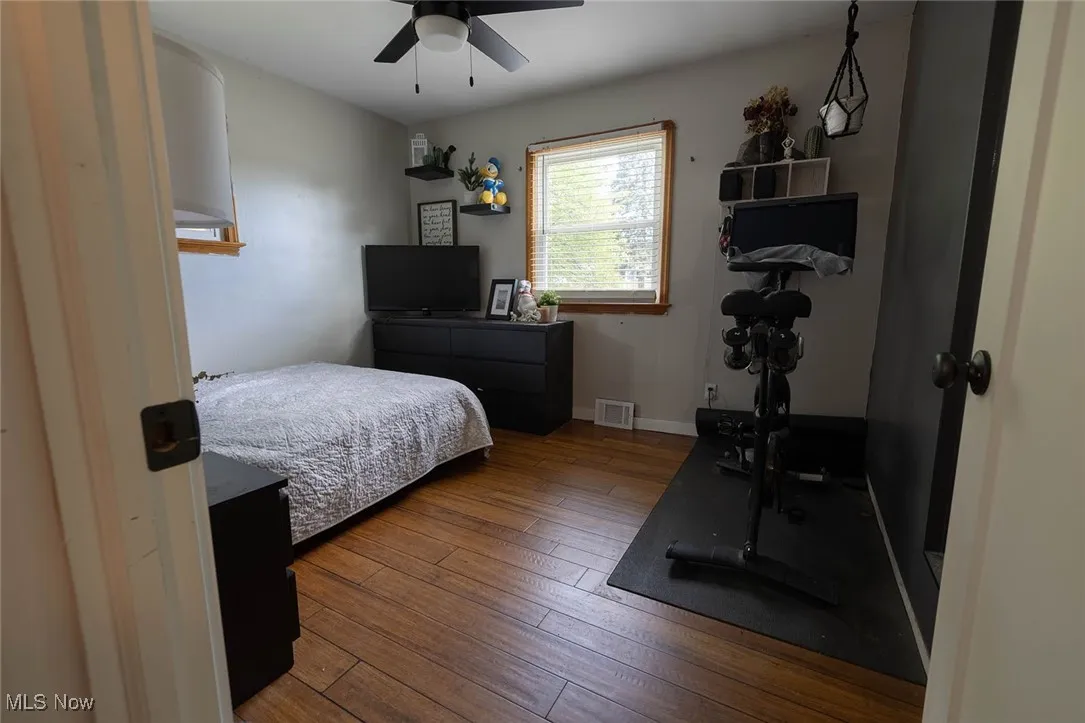 Bedroom featuring wood-type flooring and a ceiling fan