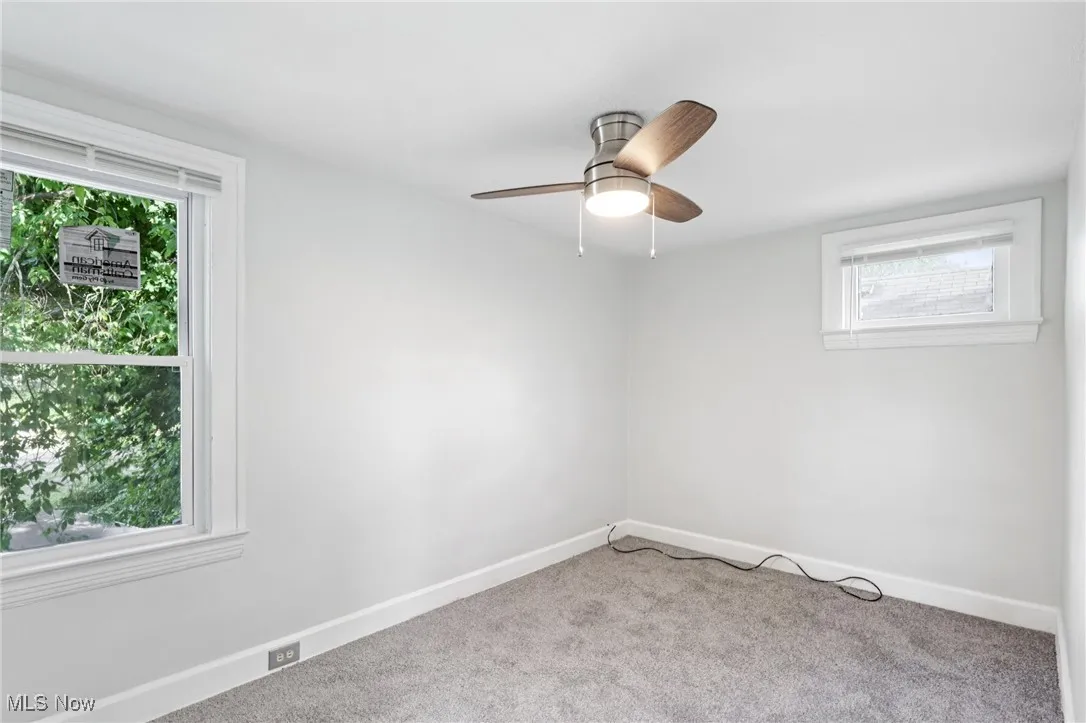 Carpeted empty room featuring baseboards