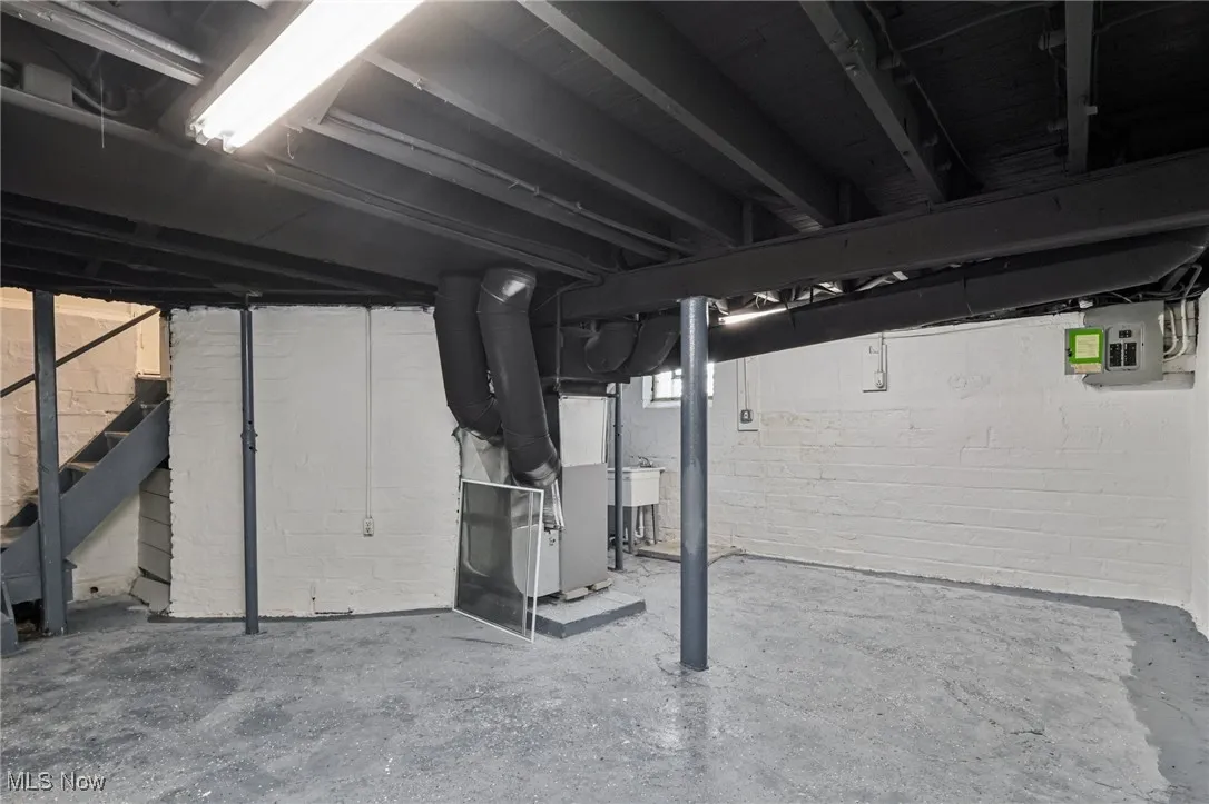 Basement with stairs and heating unit