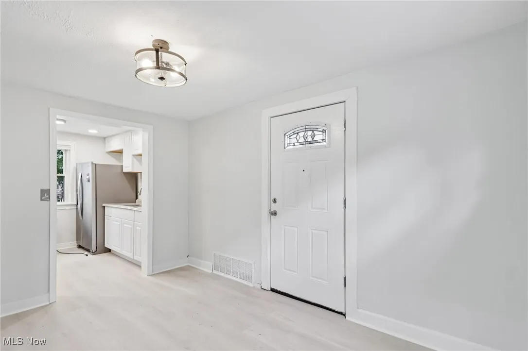 Entryway featuring light wood-style floors and baseboards