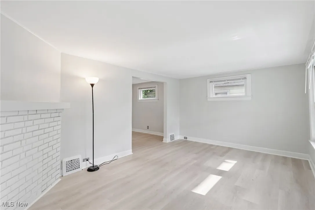 Below grade area featuring light wood-style flooring and baseboards
