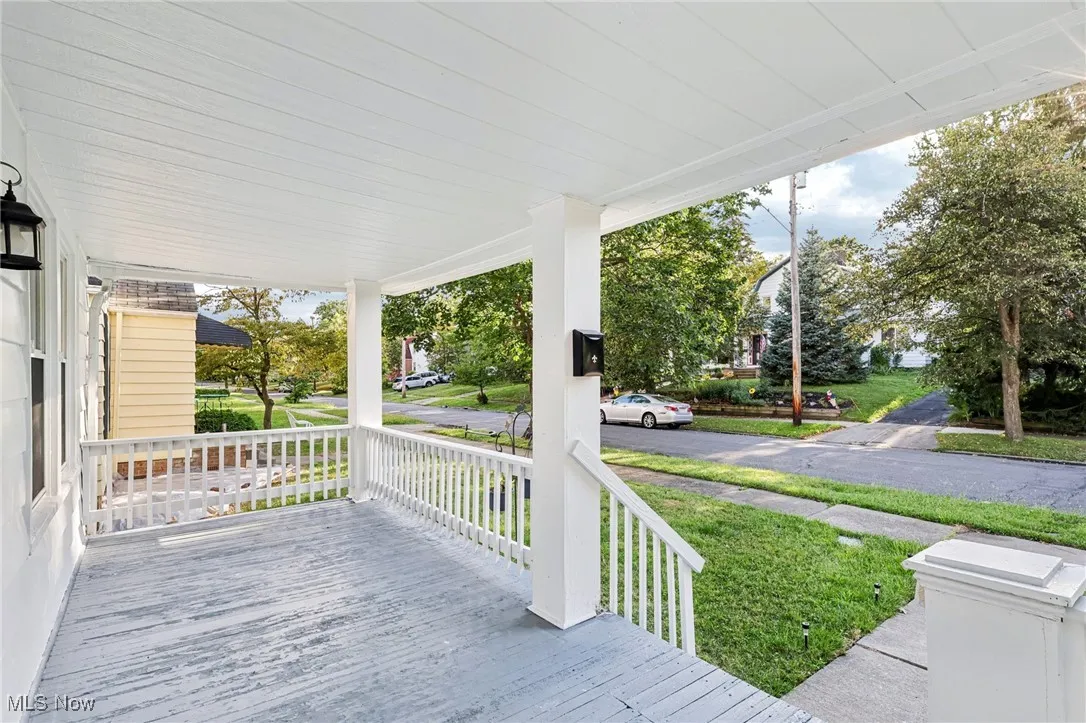 Porch featuring a lawn