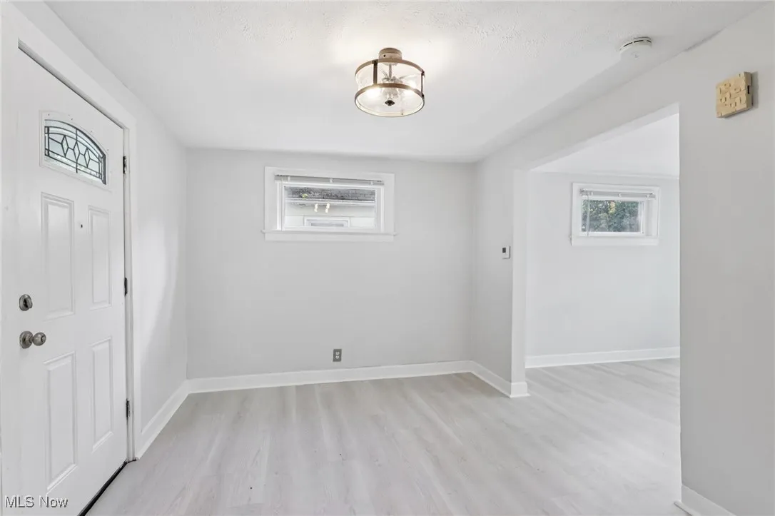 Entrance foyer with light wood-type flooring and plenty of natural light