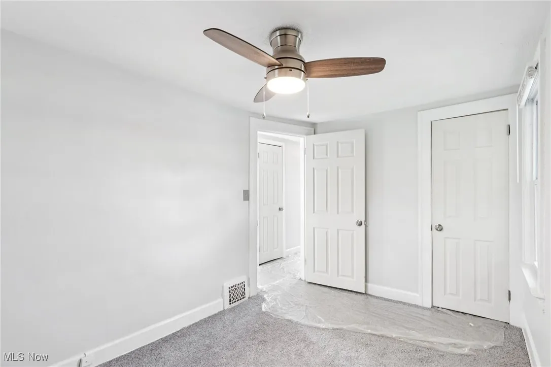Unfurnished bedroom featuring carpet flooring and a ceiling fan