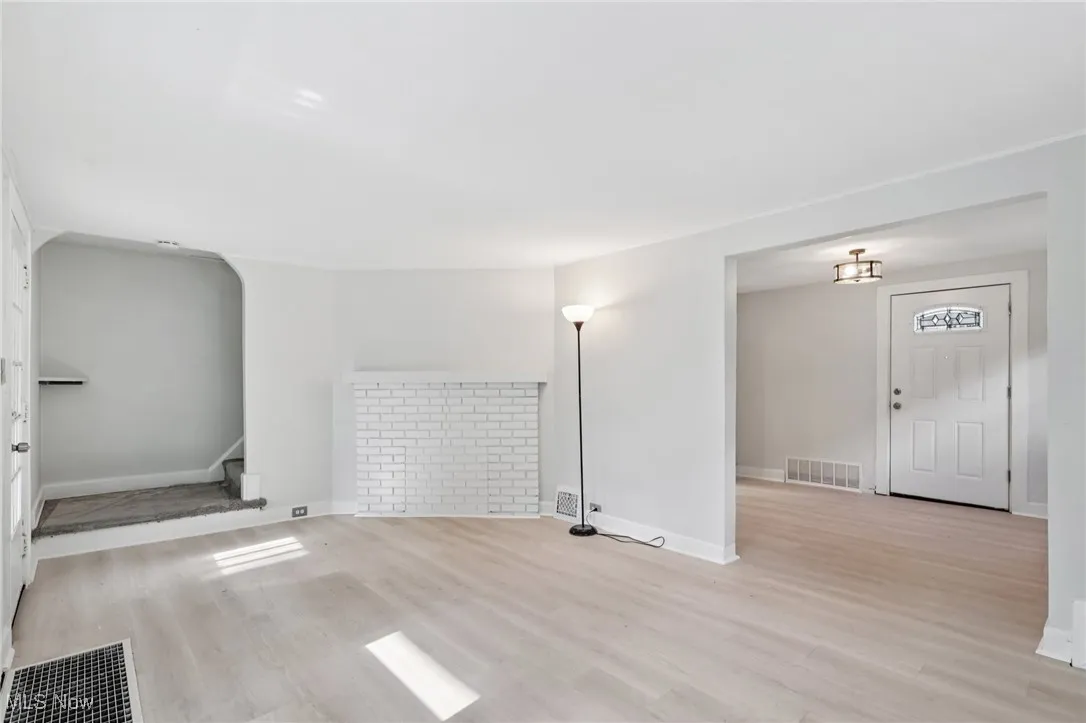 Unfurnished living room featuring wood finished floors