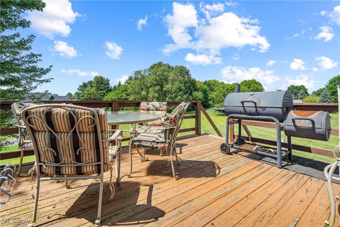 Deck with outdoor dining area and a yard