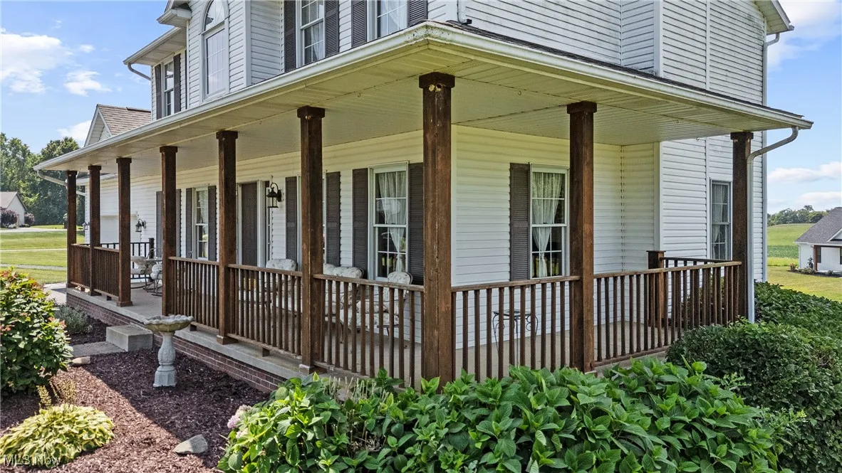 View of side of property with a porch