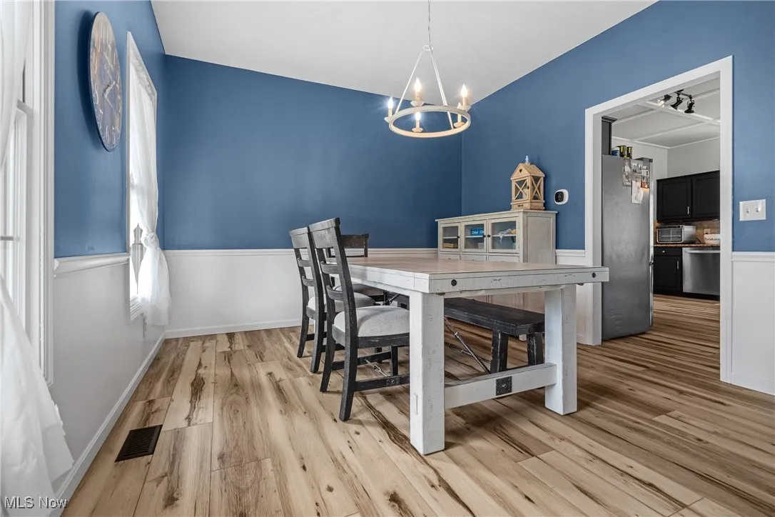 Dining space featuring light wood-style floors and a chandelier
