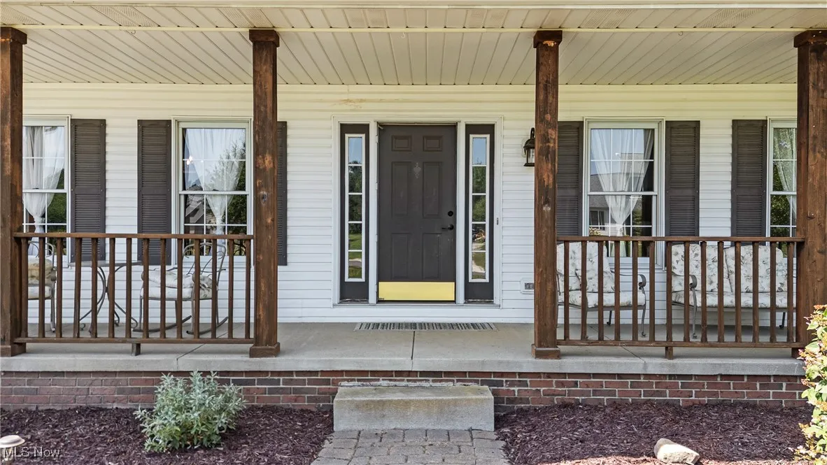 Property entrance with covered porch