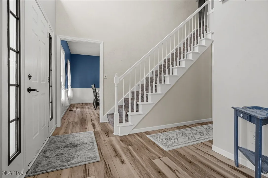 Entrance foyer featuring wood finished floors and stairway
